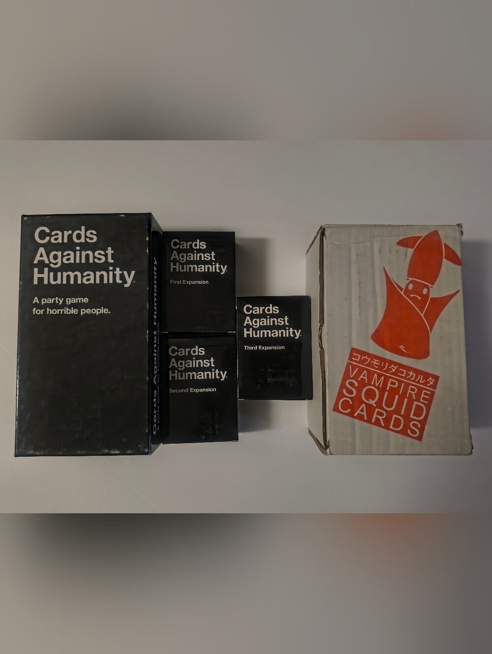 Cards Against Humanity + Crabs Adjust Humidity Game Card Sets.